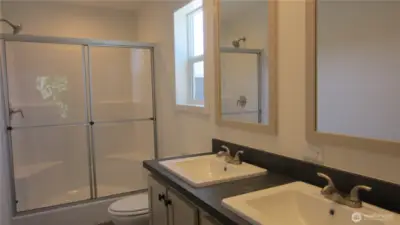 On-suite washroom with double vanities. Taken when display/model