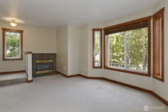 Spacious liviong room with a gas fireplace.