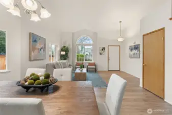 This angle highlights the welcoming entry sequence, framed by a dramatic arched window that anchors the space. The layout creates a strong sense of arrival while maintaining clear sightlines into the main living area for an open, connected feel.