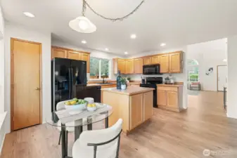 Ample counter space pairs with a full appliance suite and abundant storage for an efficient cooking setup. The layout keeps everything within reach while maintaining clear sightlines to the main living areas. Notice the laminate flooring throughout the main-level.