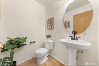 This main-level powder room features a pedestal sink, updated fixtures, and a clean, efficient layout ideal for guests. The simple design keeps the space feeling fresh and easy to maintain.