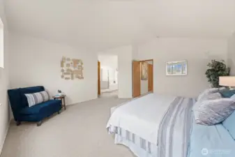 This view highlights the generous footprint of the room, offering space for a sitting area and easy flow to the en-suite bath.