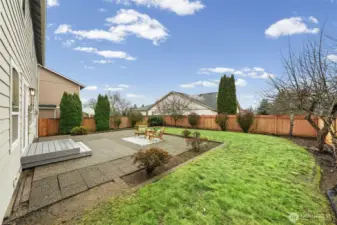 A spacious patio creates a natural extension for outdoor dining and entertaining. The fully fenced yard and level lawn provide flexibility for play, pets, or gardening.