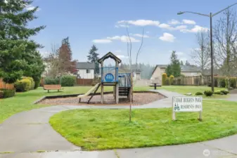This residents-only playground offers a well-maintained play structure, open green space, and paved paths, creating a great spot for outdoor play and neighborhood connection. The setting provides a convenient amenity just steps from home for everyday enjoyment.