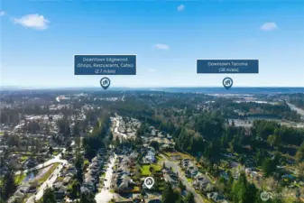 Expansive aerial view illustrating the home’s location near Downtown Edgewood’s shops and dining, with regional access toward Downtown Tacoma.