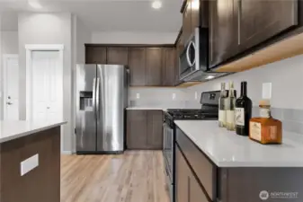 Kitchen view three from dining area, plenty of counter space and cabinets for storage.