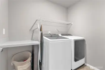 Upstairs laundry, SO convenient! Love the folding table and storage rack.