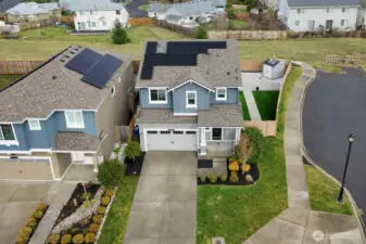Drone view of the front of the property, newer solar panels! Dead-end right next door offers additional parking for you and your guests.