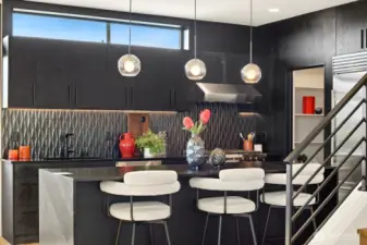 Entertainment sized island with leather ablsolute black granite countertops.