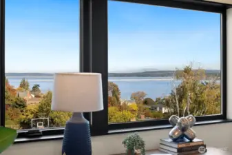 One of the upper bedrooms is staged as an office. It overlooks the lake and City of Bellevue skyline view in the distance.