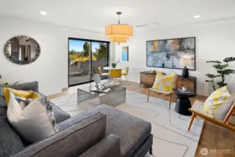 Lower level has a living room, dining area, second kitchen, sauna with cold plunge, a full bath and a spacious bedroom. Access to the fully fenced level backyard is through the slider pictured above.