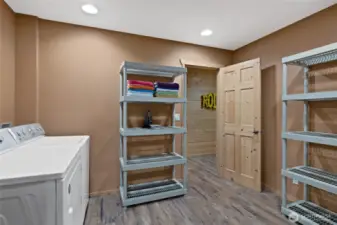 Basement Utility Space: The basement of this house features a utility space with a washer, dryer, and tons of storage.