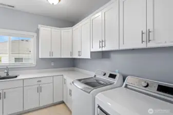 Large main floor utility room with lots of storage.