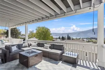 Lower-level composite deck.  Gas fire table and sectional.