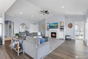 Great room with vaulted ceiling and fan.  Gas fireplace.  Double front doors.