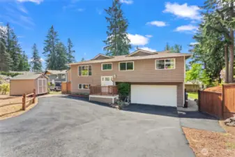 With ample room for parking, the fresh approach to the home is so inviting. Notice the shed to the left for added storage needs. Let's go inside!