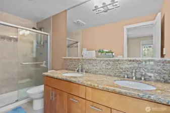 I love the glass shower doors for easy cleaning and the shower tiles that go all the way to the ceiling!  Also, the higher countertop and the dual vanity is almost as nice as the over-sized mirror - Wow!