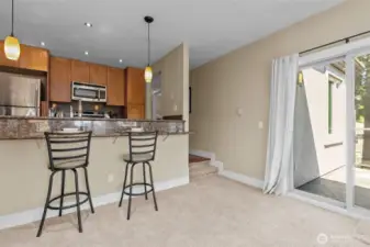 In addition to the windows, there is a sliding glass door to an east-facing balcony.  Just 2 stairs into this portion of the main living area.