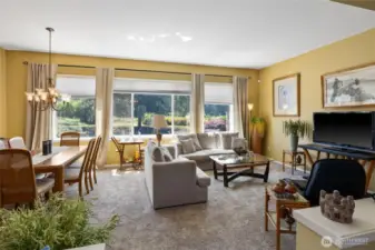 Living room with dining room opens up to the back yard views.