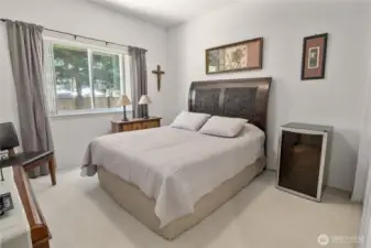 Bedroom three neutral colors in here and views looking into the side yard, lots of light in here.