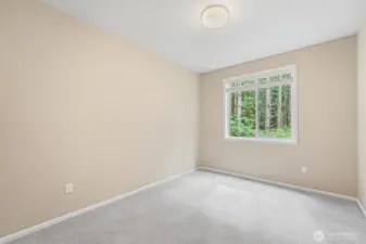 Main floor bedroom with wooded view.