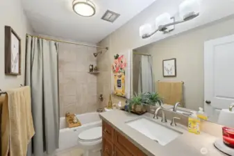 Second full bath includes a tub with full-height tile surround plus Quartz counters and tile floors