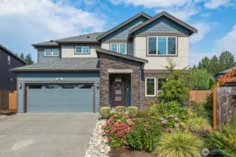 Front view of home with lovely landscaping.
