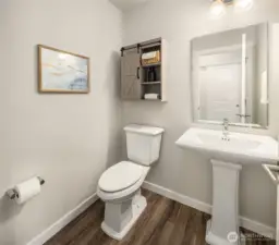 Half bath between the Great Room and garage entry. Opposite from it is another coat closet.