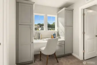 As you reach the upper level landing, this beautiful desk area with built-in storage cabinets greets you. The door on the right leads into the laundry room.