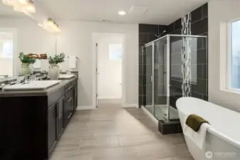 Primary suite bathroom has a soaking tub, walk-in shower, dual sinks vanity, and separate toilet room.