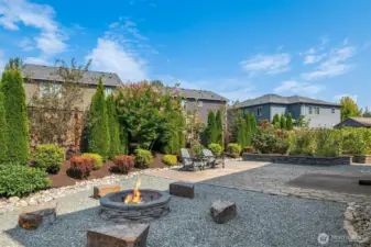 For those who prefer not to spend a weekend mowing, this professionally landscaped back yard offers a beautiful firepit with seating, a large patio waiting for your el fresco dining, raised flower bed and raspberry bushes bed, a pet care area, a garden shed, and easy care maintenance.