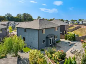 Aerial view of the back yard and back exterior of house.