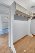 Closet area between bedroom and bathroom.