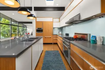 In design the term "white space" or "negative space" refers to the imperative of allowing for visual or actual breaks between other design elements.  Here white-painted cabinets in turn visually recess and then pop against the walnut frames, creating a sense of playful movement.