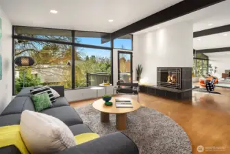 A two-sided wood-burning fireplace offers warmth, ambiance, and additional seating; as well as helping to delineate the different living spaces.