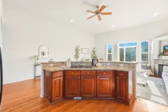 Breakfast bar opens to the living and dining rooms for a social, connected layout.