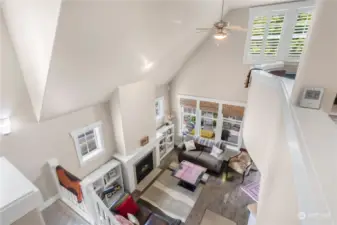 Looking down on the living room from the upper floor. Cool curved wall for the open media room.