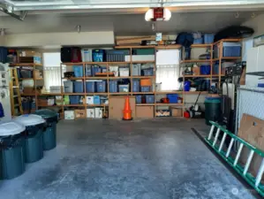 Inside the 765 sq ft garage is built-in storage. Stacking washer dryer on the left.