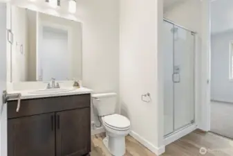 Main floor 3/4 bath adjacent to guest suite. Layout will be slightly different. Pics not of actual home, but similar floorplan and may contain upgrades.