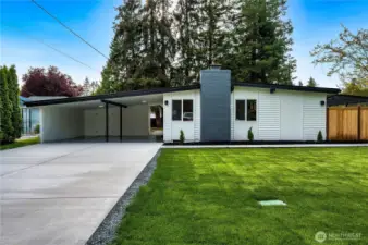 new concrete driveway that leads to side front door