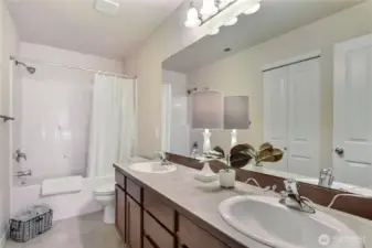 The upstairs main hall bath is bright and modern, featuring clean lines and a double vanity for added convenience. Its fresh design creates a welcoming space that’s perfect for busy mornings or relaxing evenings. Plenty of light and thoughtful details make this bathroom both stylish and functional. It’s a great shared space for family or guests.