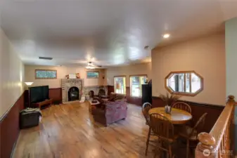 Family Room Designed For Both Relaxation & Entertaining. Featuring Large Windows, Rich Laminate Hardwood Floors, & Striking Wall Fireplace-All Creating a Timeless Style That's Truly Hard To Find.