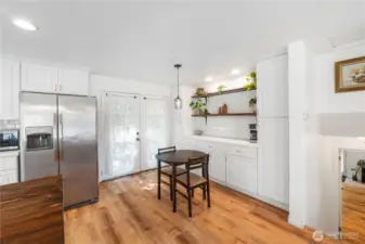 Lots of storage and serving space with built in cabinets and extra countertop.  Stroll through the French doors to go to spacious fenced yard!