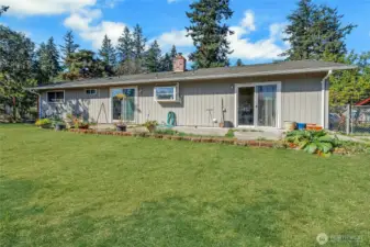 Back yard facing home. Huge patio, 2 sliding glass doors. Lot's of room for entertaining! Grass has been photoshopped to look green!