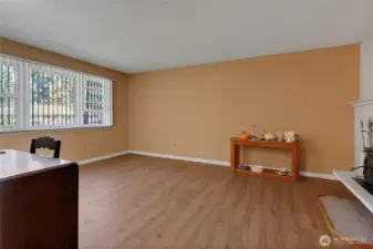 Front living room with beautiful wood burning fireplace.