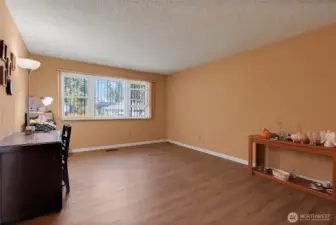 Nice size living room with laminate flooring.