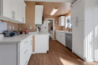 Newer kitchen with white cabinets and quartz counter tops. All appliances stay!