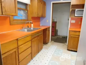 Kitchen with laundry room in the back ground