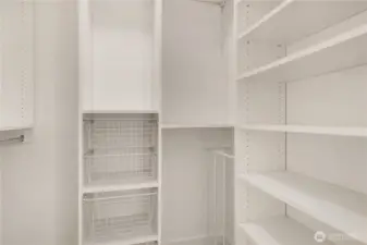 Walk-in closet with shelving system.