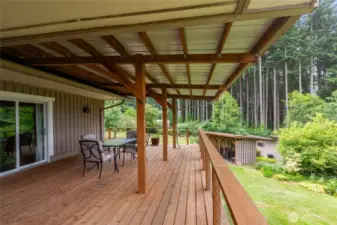 Accessible from both the dining area and the primary bedroom, this covered deck is a peaceful retreat perfect for enjoying your morning coffee or evening views while being seamlessly connected to your home’s indoor living spaces.